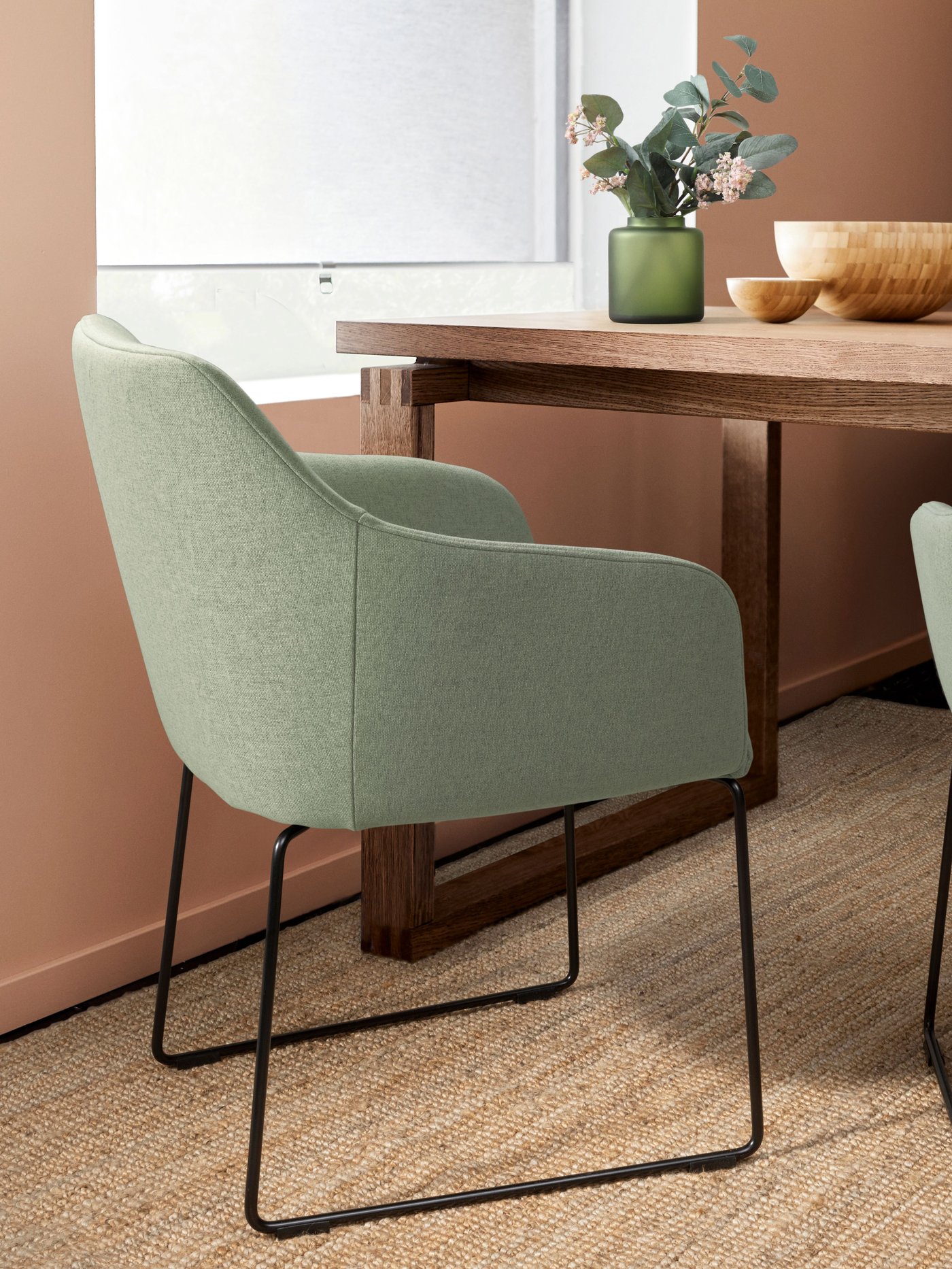 A metal black/Gunnared light green TOSSBERG chair with black legs in the dining room.