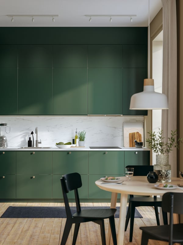 A deep green IKEA HAVSTORP kitchen.