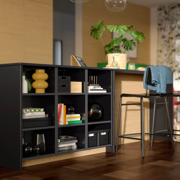 A dining area with storage with a METOD black/grey frame with a MÖCKLARP custom-made worktop and STIG barstools.