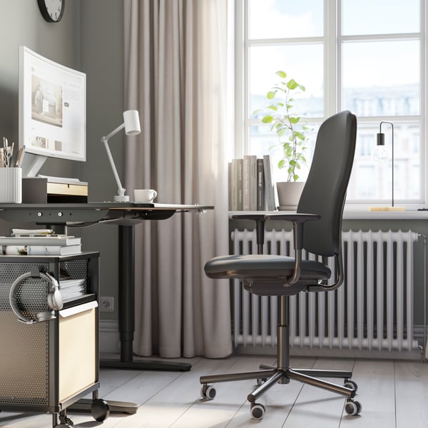 A Gräsnäs dark grey SMÖRKULL office chair with armrests