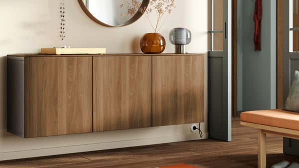 A black-brown Lappviken/brown walnut effect BESTÅ wall-mounted cabinet combination in the hallway