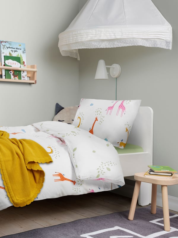 A children's bed with colourful bed linnens
