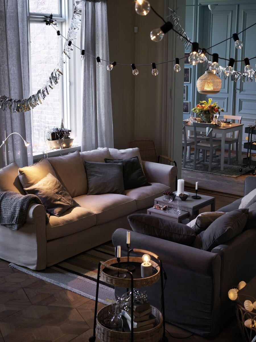 Two HÄRLANDA sofa beds stand facing each other in a calm-looking living room, with a LUBBAN trolley beside one of them.