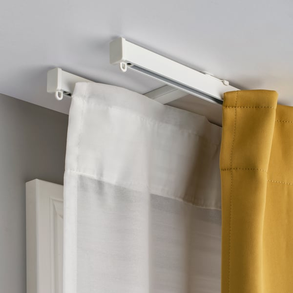 A drawing of a window showing two different options for curtain rods placement.