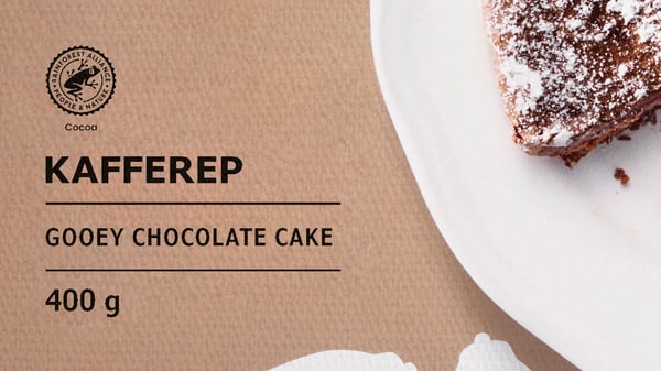 A packet of KAFFEREP gooey chocolate cake showing a piece of cake on a white pate and the Rainforest Alliance cocoa logo.