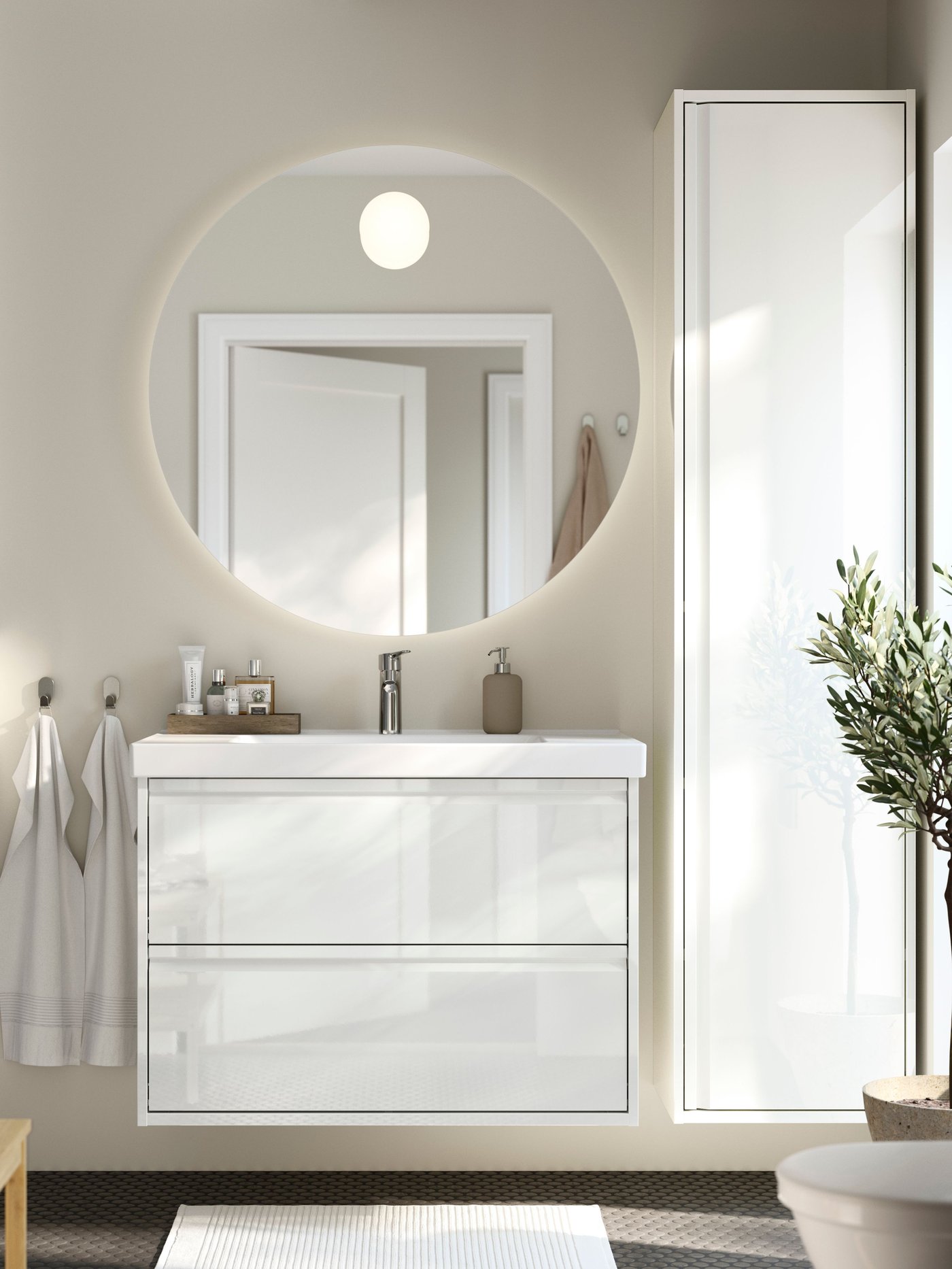 A high-gloss white ÄNGSJÖN high cabinet with door