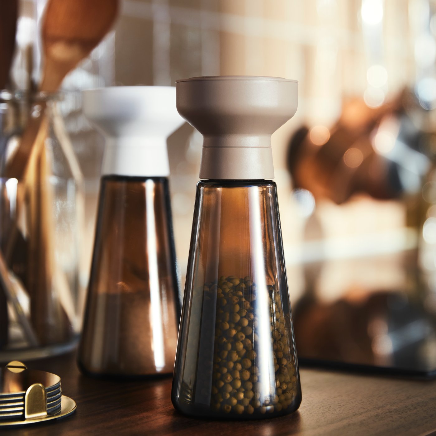 A glass/brown HALVTOM spice mill