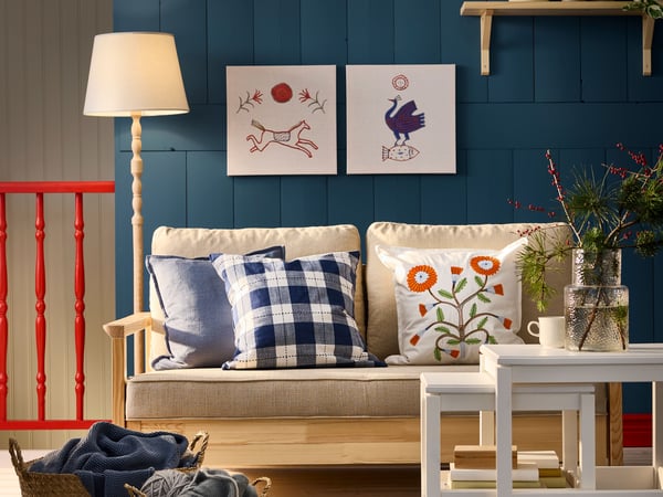 Une housse de coussin LAGERPOPPEL bleu-gris dans le salon