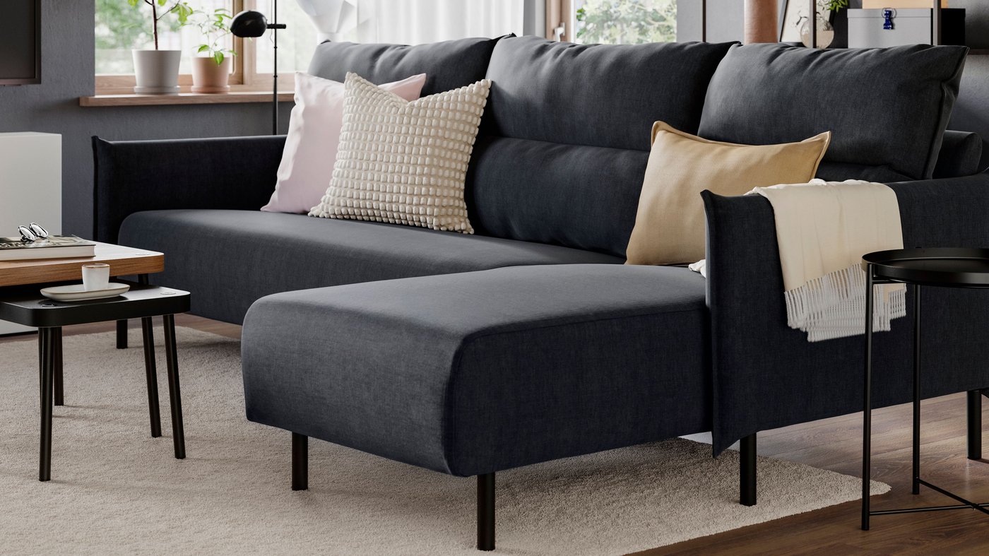 An off-white SVARTPOPPEL cushion cover in the living room