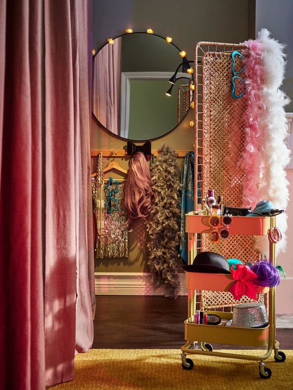 a mirror and a cart with accessories and decorative lighting