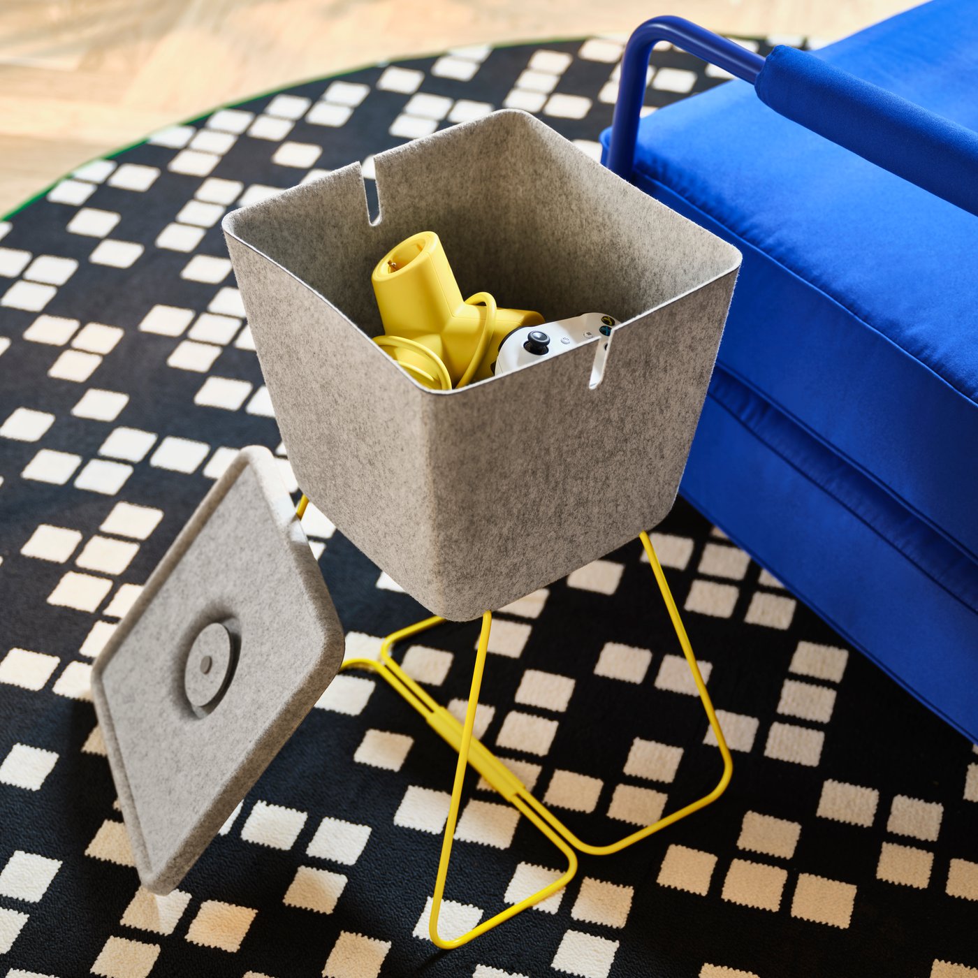 A grey/yellow BRÄNNBOLL basket in the living room