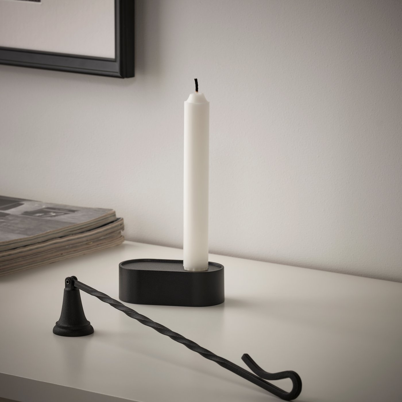 A black KÖRSBÄRSTRÄD candle snuffer