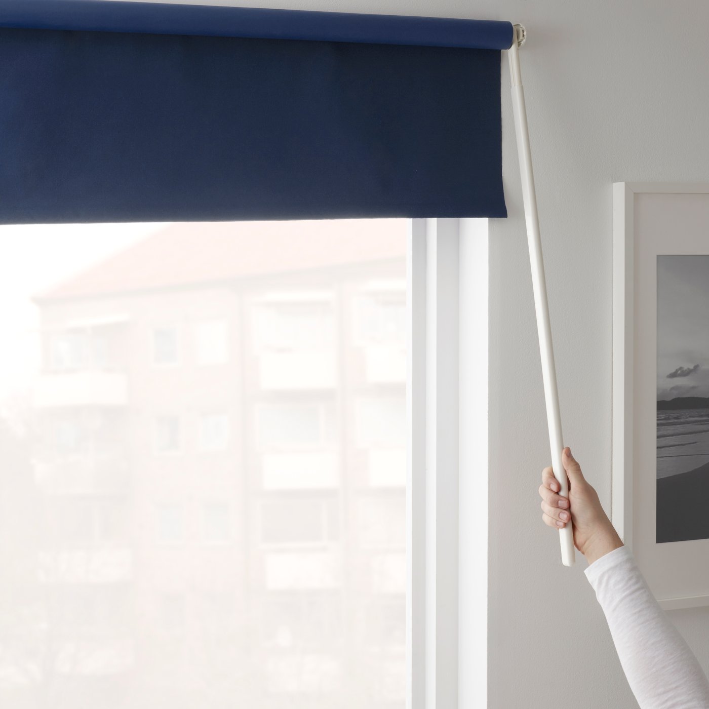 A blue FRIDANS block-out roller blind