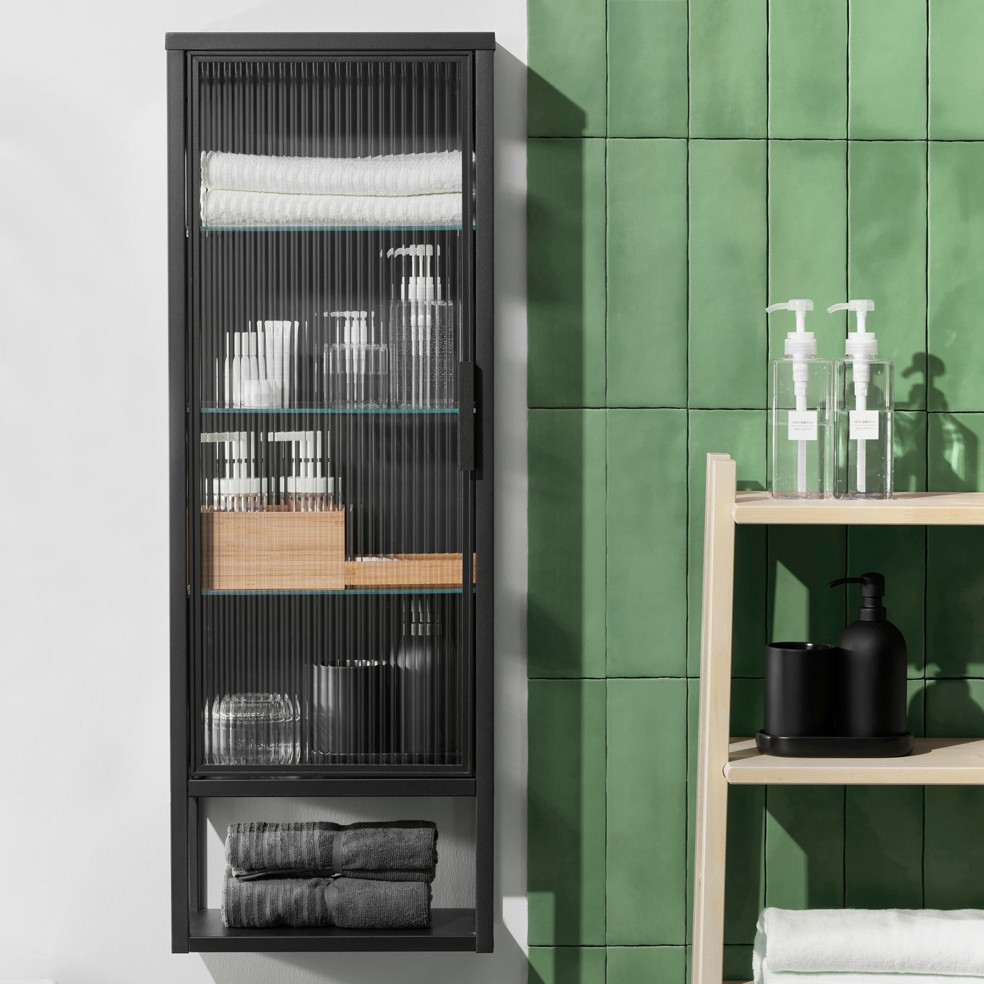 An anthracite MOSSJÖN wall cabinet w shelves/glass door in the bathroom