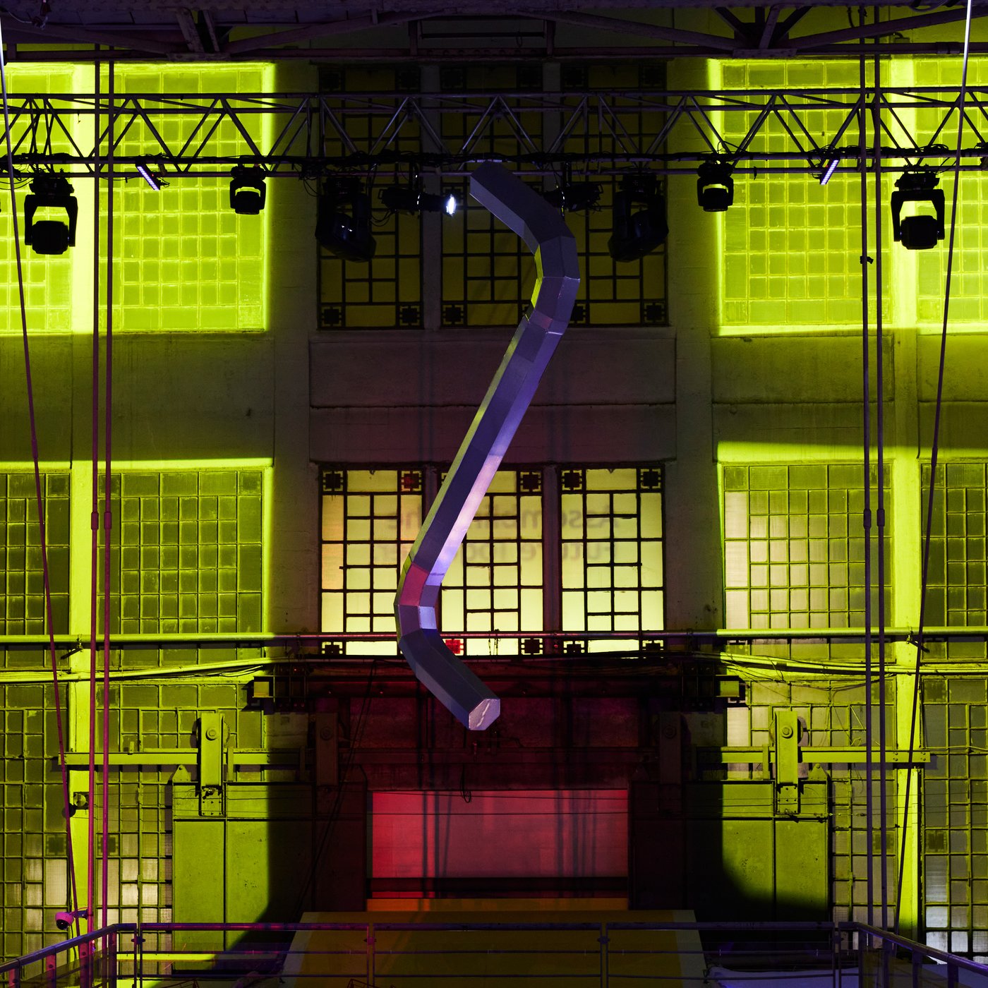 Inside a factory with a yellow background and decoration. 