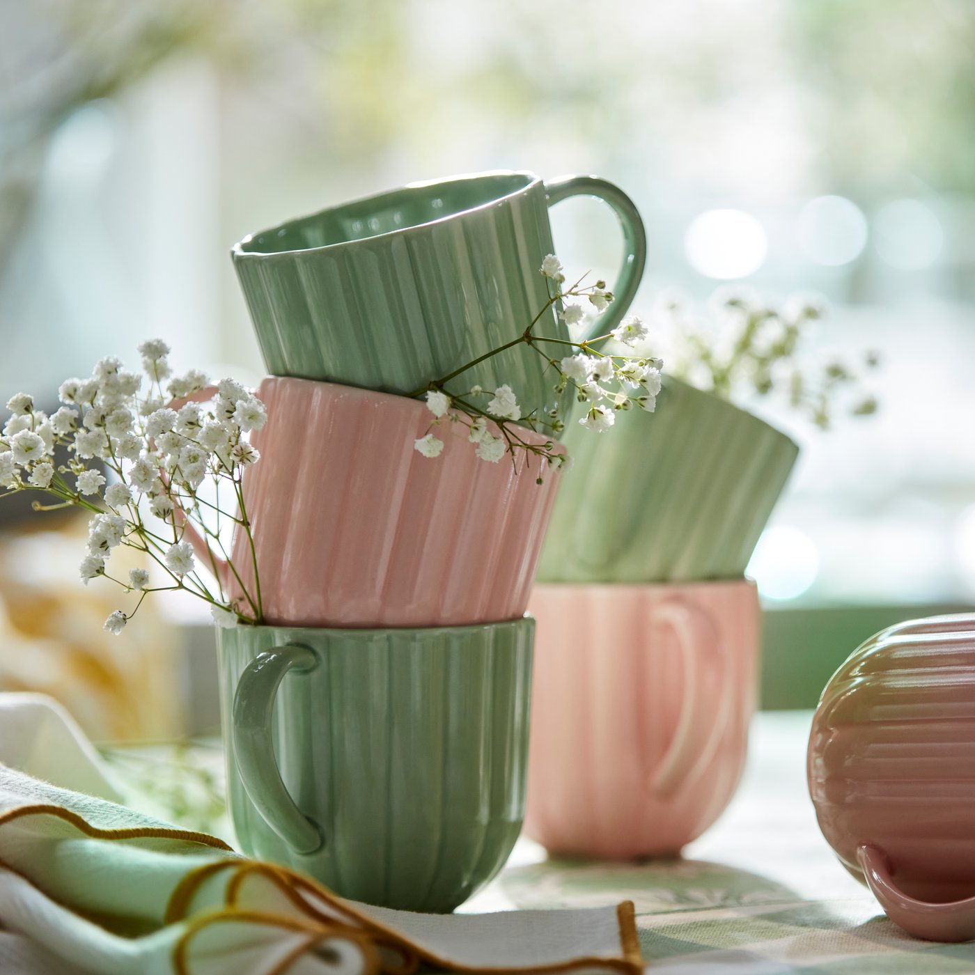 A light green/pink SMÖRFISK mug in the dining room