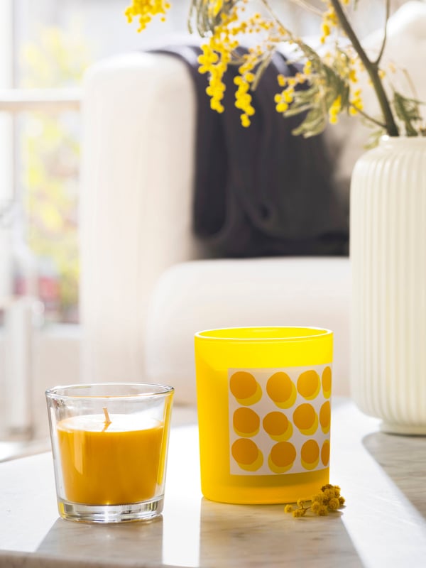 A Mimosa/yellow SVARTOXBÄR scented candle in glass