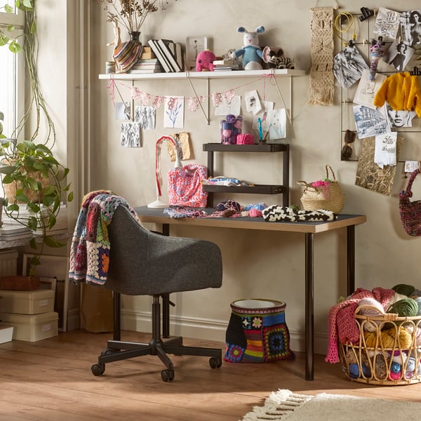 A grey/wood effect black LAGKAPTEN desk