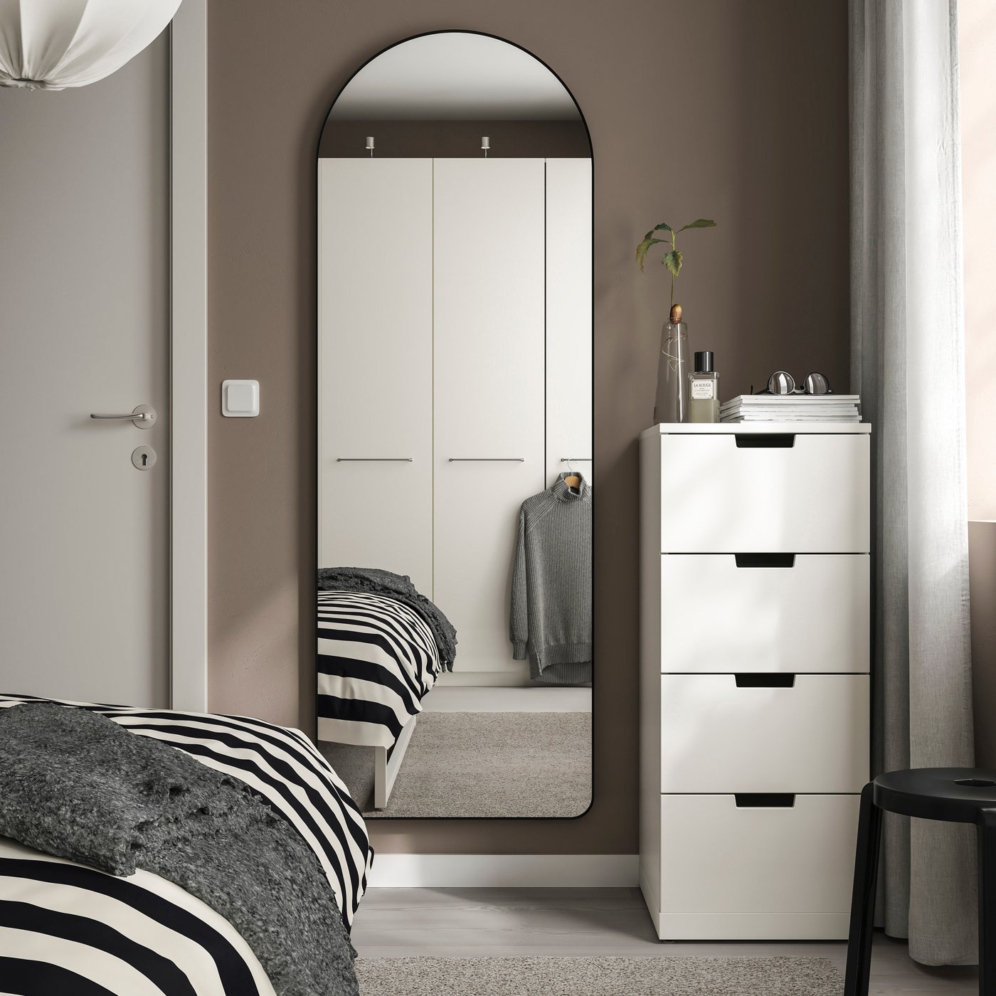 A black LINDBYN mirror in the bedroom