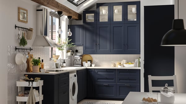 A small blue colour shaker style kitchen