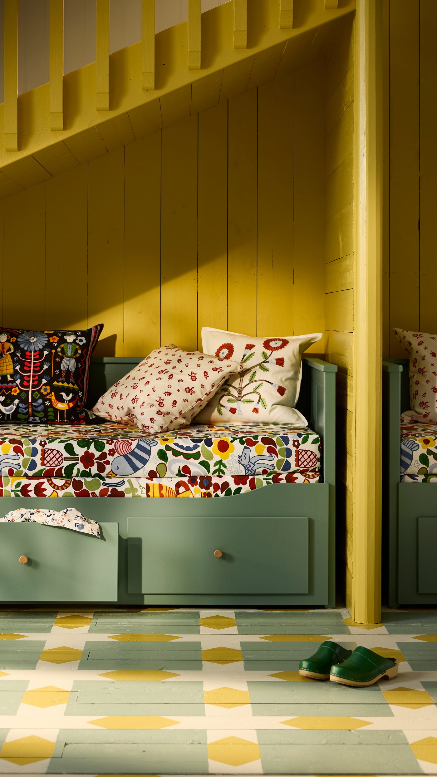 A grey-green HEMNES day-bed frame with 3 drawers