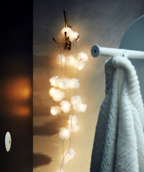 An indoor/tulle white LIVSÅR LED lighting chain with 24 lights in the bedroom