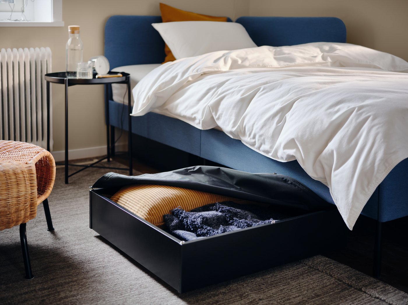 A Knisa medium blue BLÅKULLEN uph bed frame with corner headboard