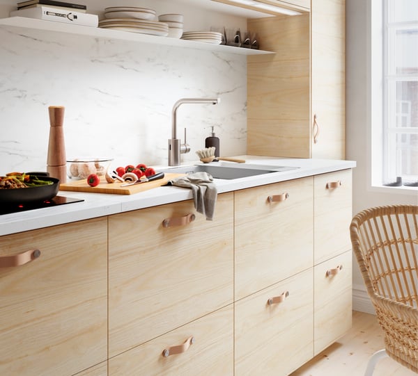 A white BOTKYRKA wall shelf in the kitchen
