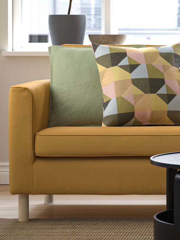 A multicolored SVARTHÖ cushion cover