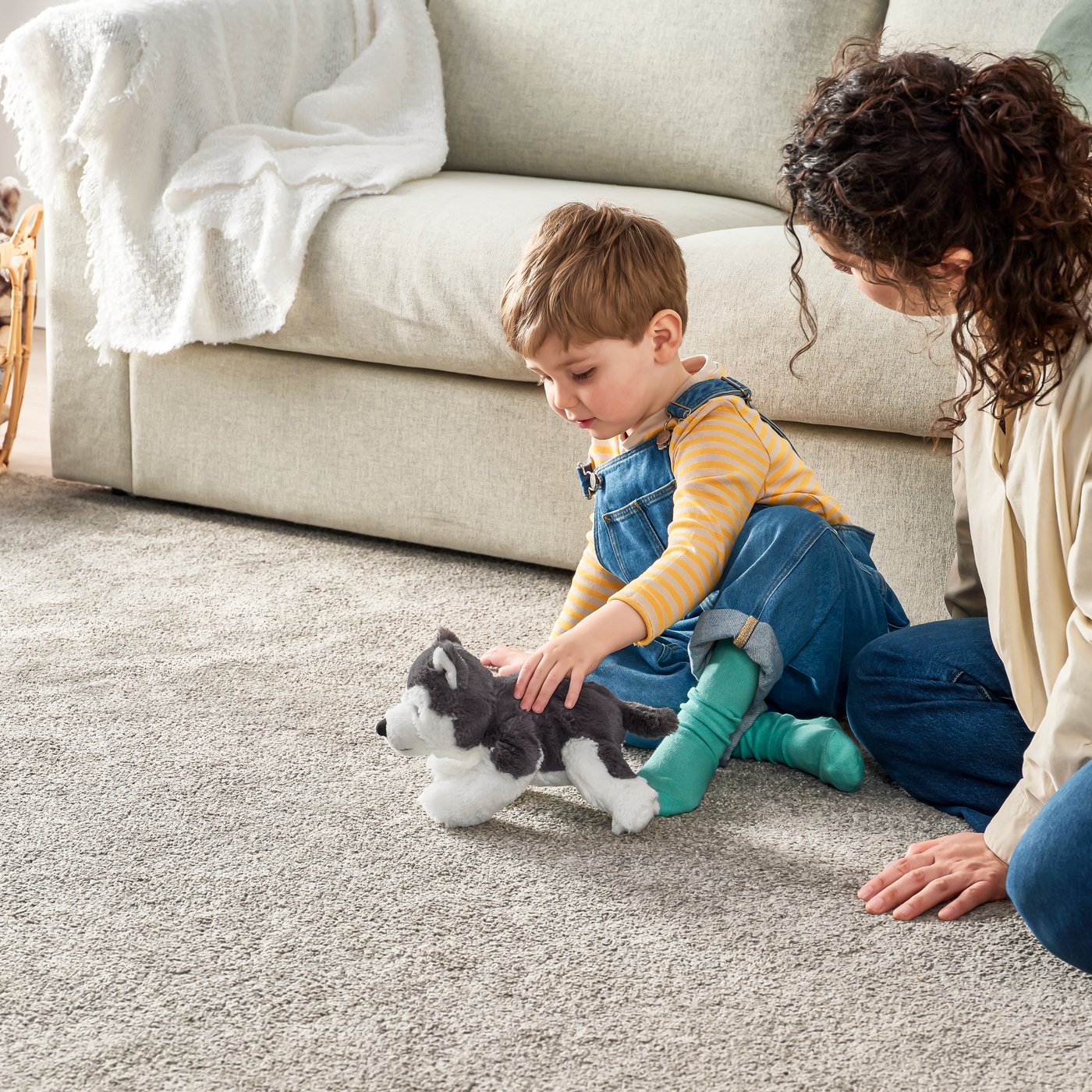 A dog/siberian husky LIVLIG soft toy in the living room