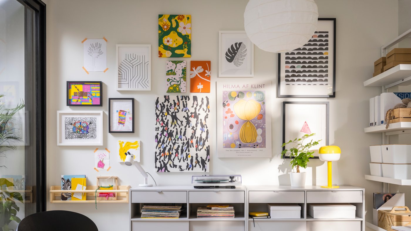 Wall-gallery with colourful pictures inside of the frames. 