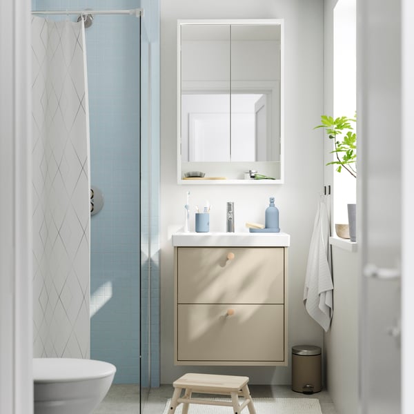 A frontal view of a dark grey HAVBÄCK wash-stand with drawers and an ORRSJÖN wash-basin under a mirror cabinet.