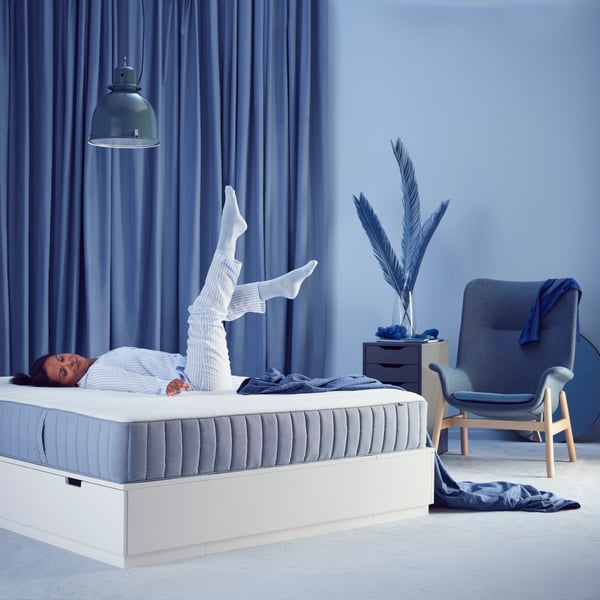 A firm/light blue VALEVÅG pocket sprung mattress