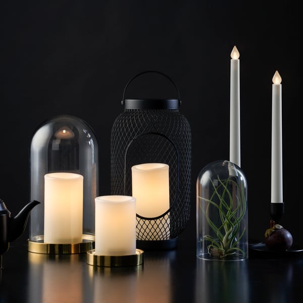 ÄDELLÖVTRÄD electric block candles in black lanterns in a spooky tab setting.