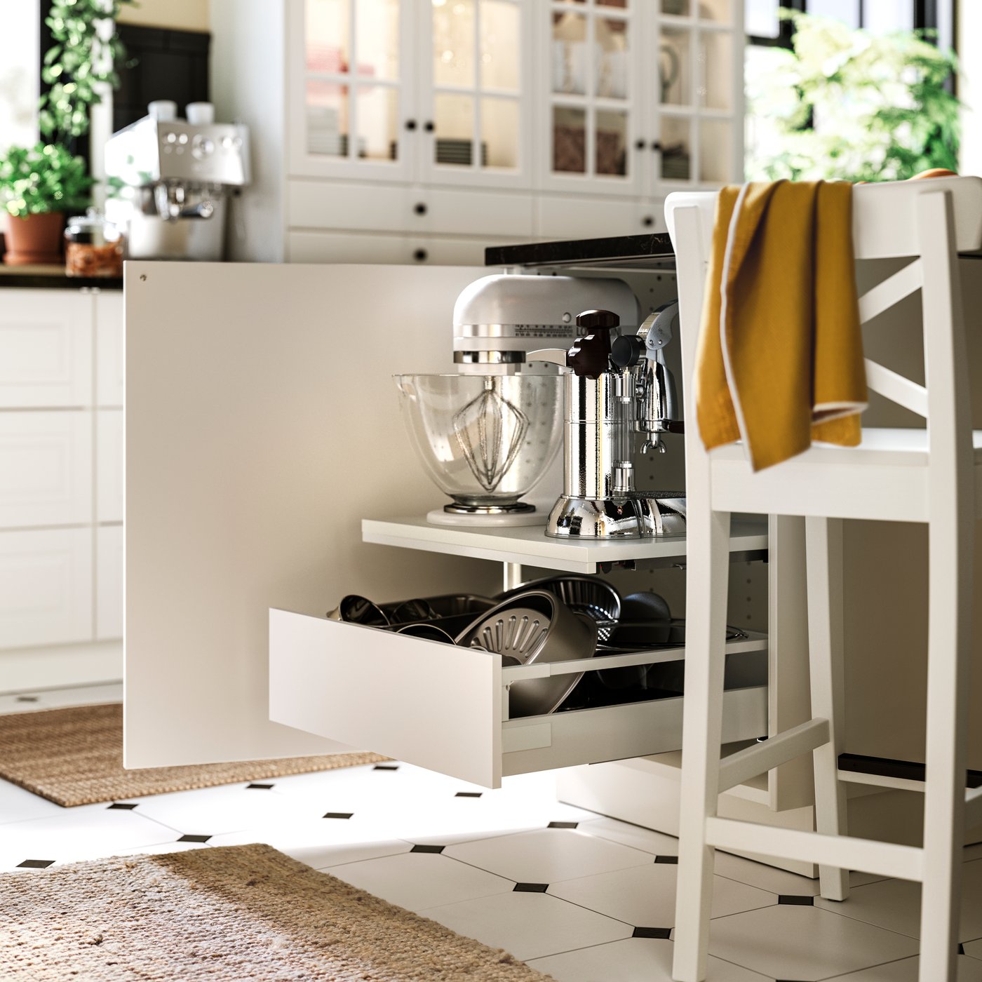 A kitchen with UTRUSTA pull-out work surface extended, holding a stand mixer with bowl and placed above a drawer.