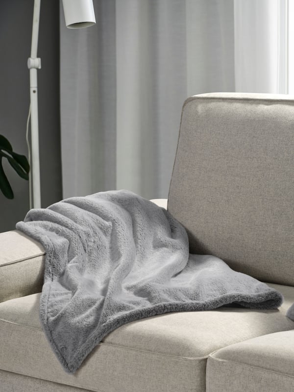 A grey ULLGRIMMIA throw