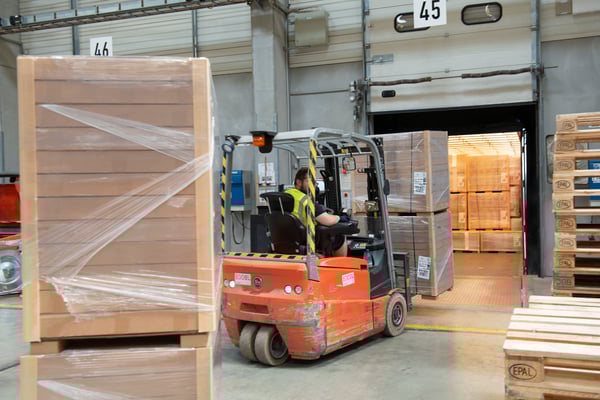 A forklift transporting boxes in the IKEA warehouse.