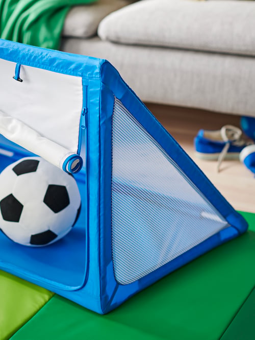 A SPORTSLIG toy goal with storage, its zippered mesh front halfway down, with a black-and-white SPARKA toy football in it.