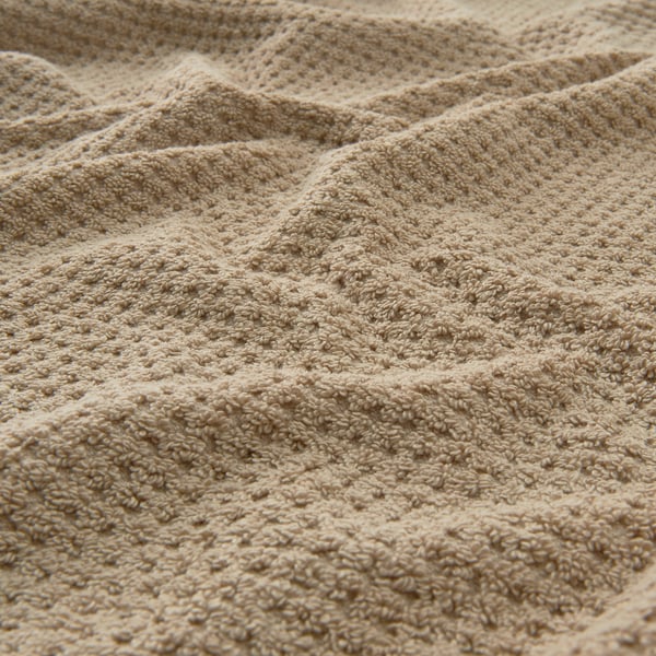 En beige GULVIAL handduk.