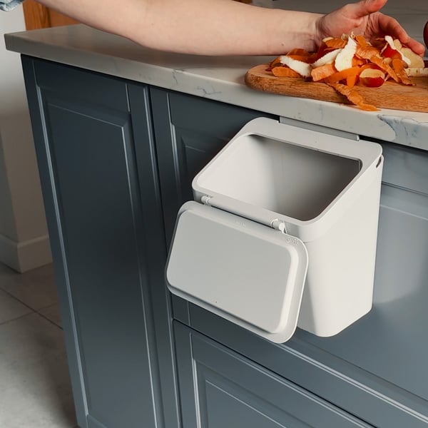 A light grey SKOLÄST waste bin for cabinet with door