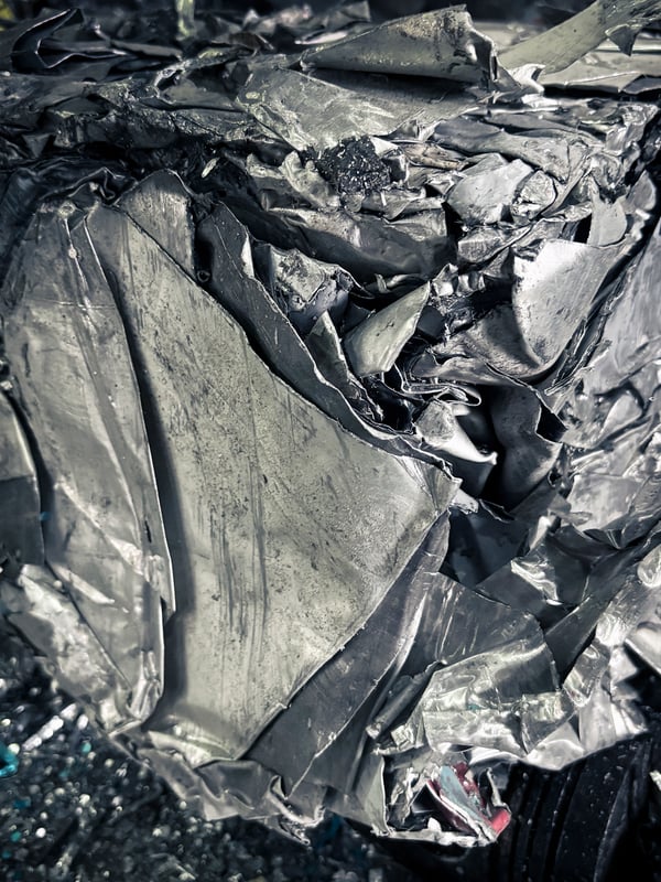A close-up image of crumpled metallic sheets.