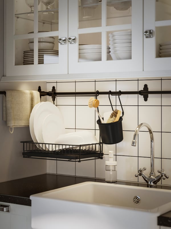 IKEA HULTARP black dish drainer hanging from a HULTARP black rail in the kitchen. 