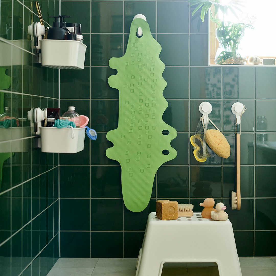 A crocodile green PATRULL bathtub mat