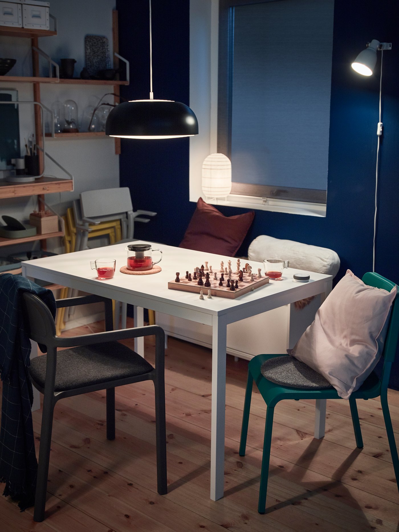 A white dining room containing an IDANÄS glass-door cabinet with plates on the wall above and an INGATORP extendable table.