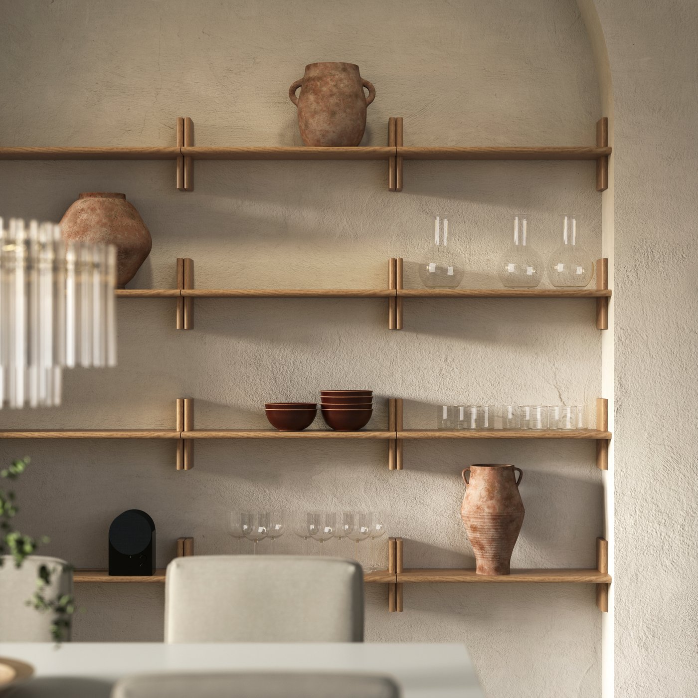 Side-by-side KLAVRESTRÖM wall shelves in solid oak with stretched h-shapes hold glassware, bowls and vases by a dining area.