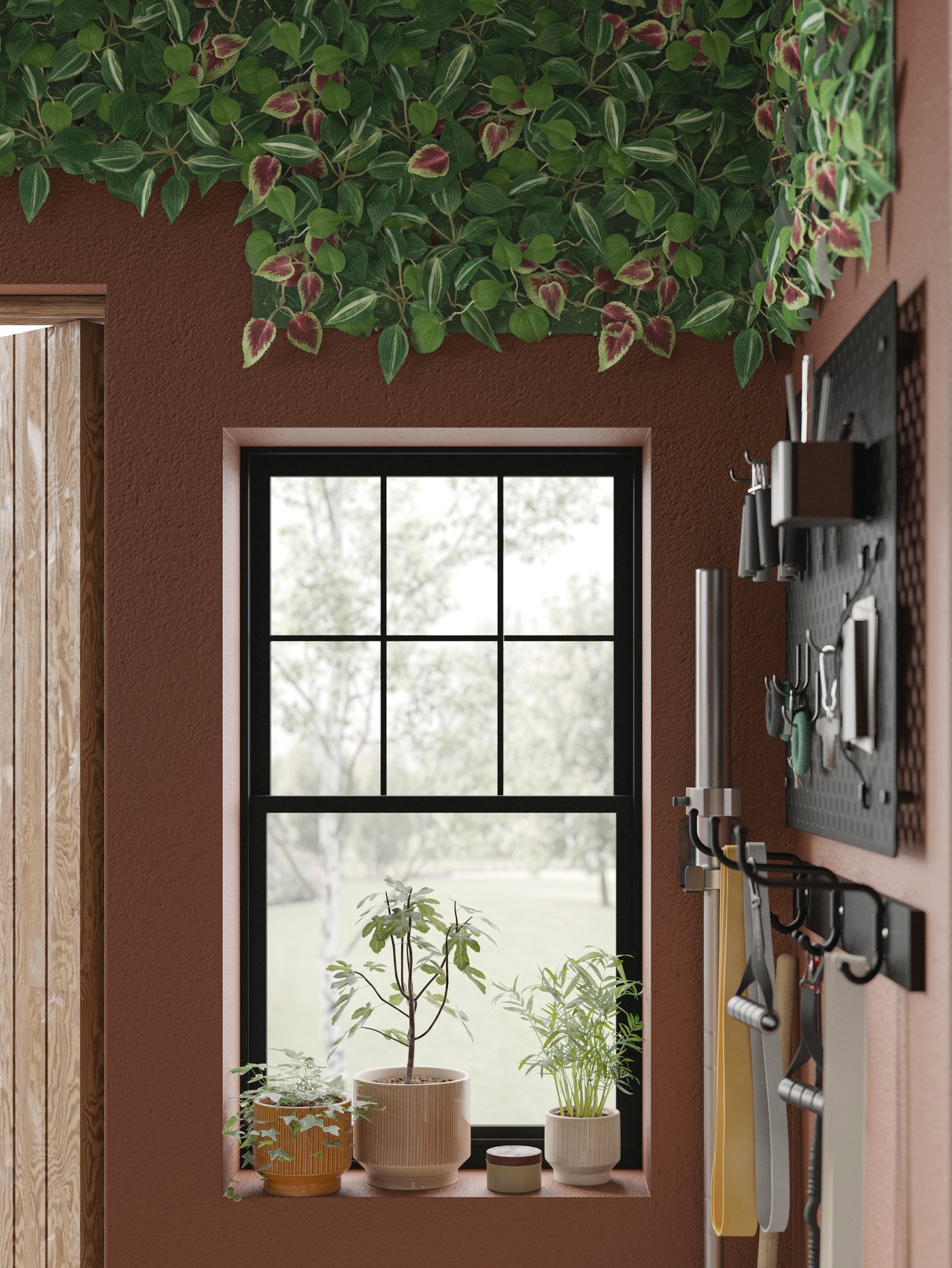 A corner with plants in a window, accessories on a pegboard and hooks, all beneath a FEJKA artificial-plant-wall arrangement.