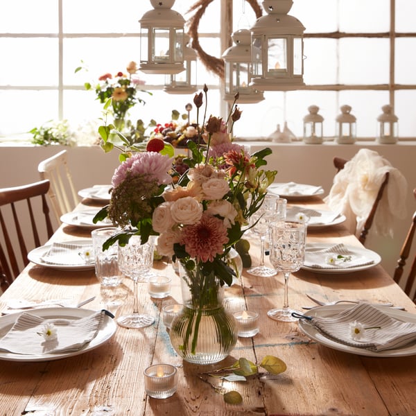 Traditional wedding table with lanterns and a floral centrepiece.