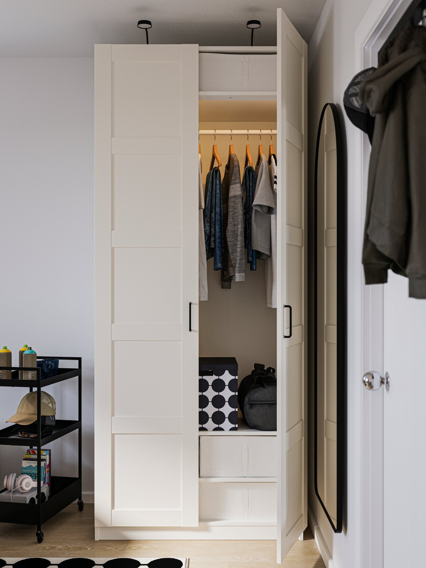 A white PAX wardrobe with one door open to show clothes in a neat order inside. Black trolley on wheels to the left.