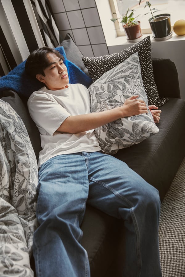 A Vissle dark grey LINDÅKRA 2-seat sofa-bed