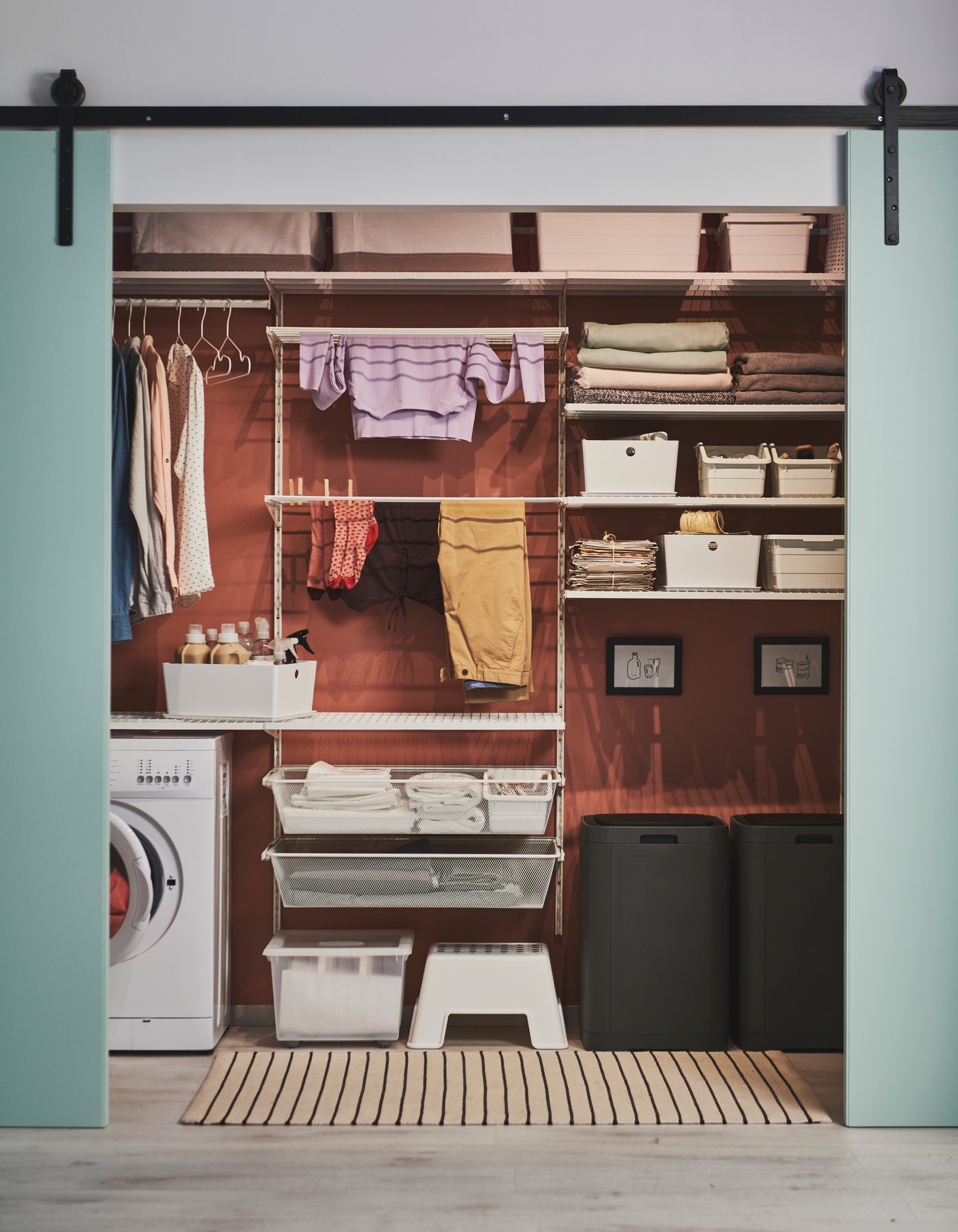 A white BOAXEL mesh basket in the laundry room
